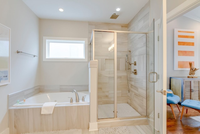 full bathroom with a shower stall, a bath, and recessed lighting