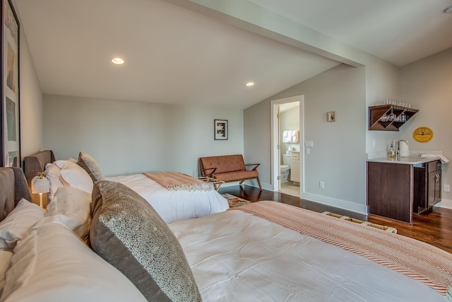 bedroom featuring recessed lighting, a sink, vaulted ceiling, wood finished floors, and baseboards