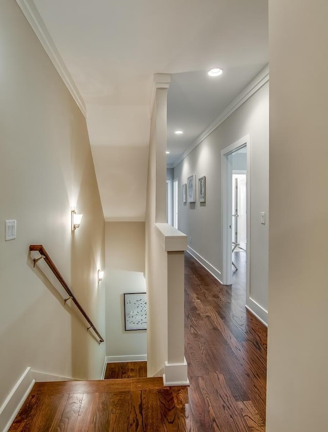 corridor with recessed lighting, an upstairs landing, baseboards, ornamental molding, and dark wood finished floors