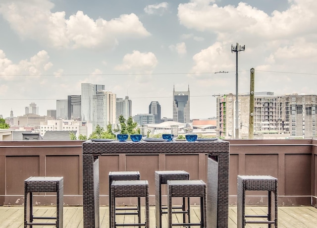 view of patio featuring outdoor dry bar and a view of city