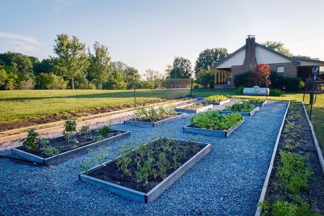 exterior space featuring a vegetable garden and a lawn