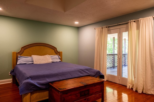 bedroom featuring access to exterior, recessed lighting, a textured ceiling, wood finished floors, and baseboards