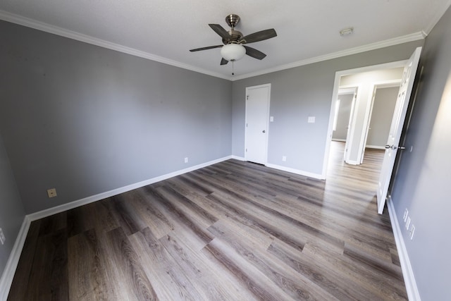 unfurnished bedroom with ornamental molding, wood finished floors, and baseboards