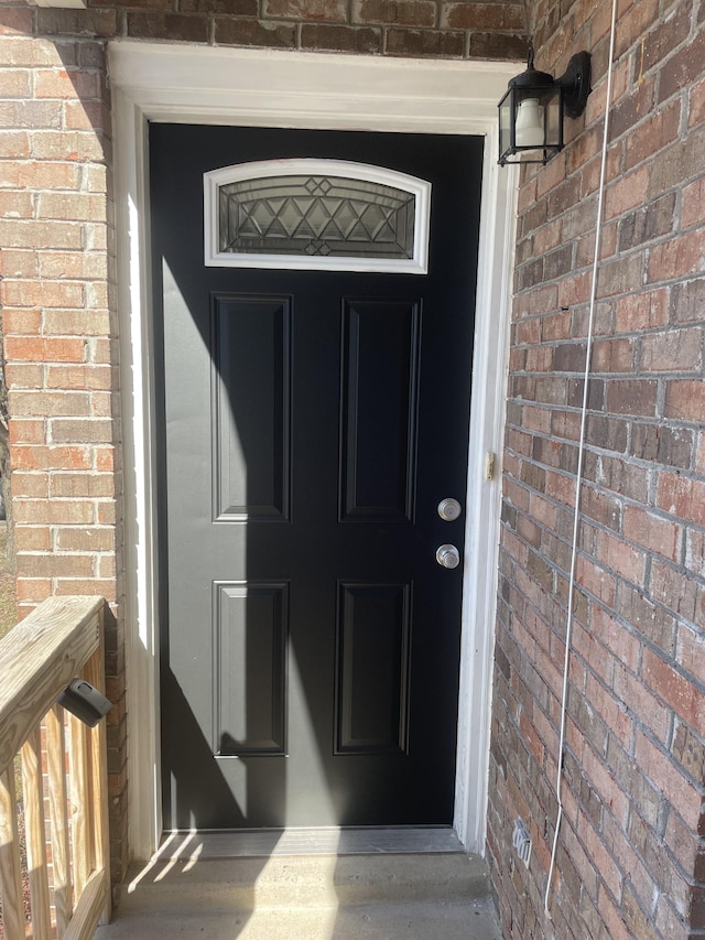 property entrance with brick siding