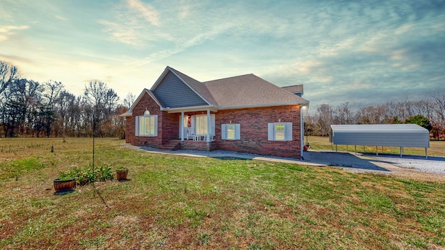 craftsman house with a carport, a front yard, crawl space, and brick siding