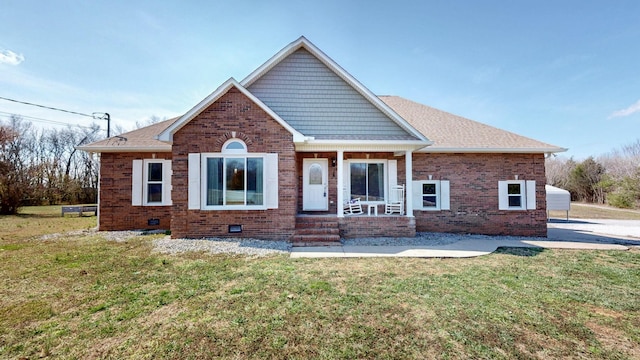 view of front facade with brick siding, crawl space, and a front yard