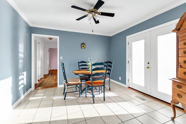 dining room featuring light tile patterned floors, baseboards, a ceiling fan, crown molding, and french doors