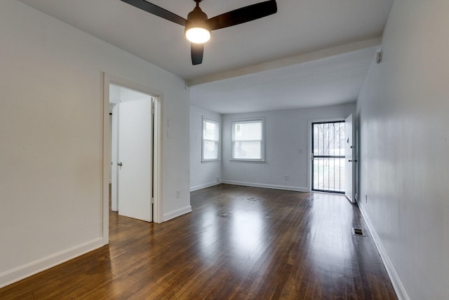 unfurnished room with dark wood-style floors, visible vents, baseboards, and ceiling fan