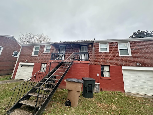 view of front of house with an attached garage, stairway, cooling unit, and brick siding