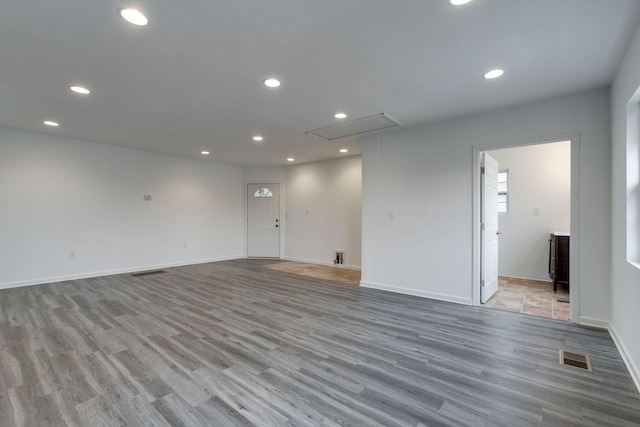 empty room featuring attic access, recessed lighting, and light wood-type flooring