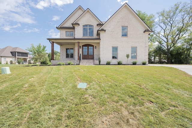 view of front facade featuring brick siding and a front lawn