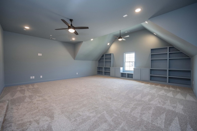 bonus room featuring built in shelves, vaulted ceiling, carpet flooring, and recessed lighting