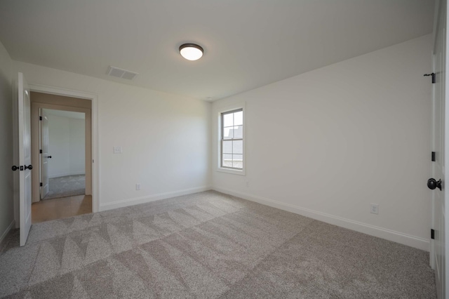 unfurnished room featuring light carpet, baseboards, and visible vents