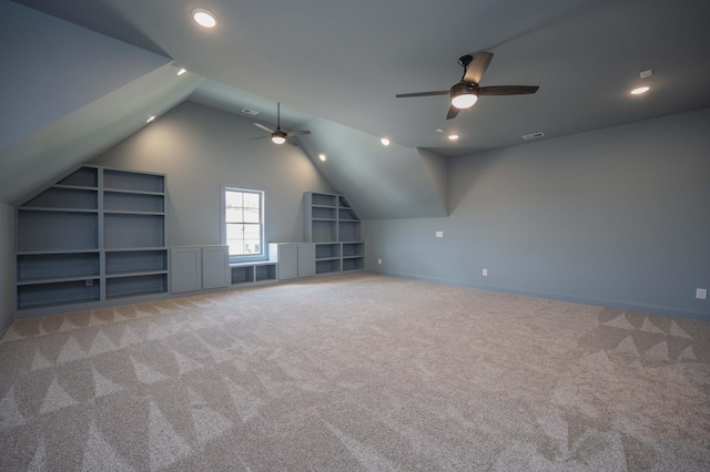 additional living space with baseboards, built in features, lofted ceiling, carpet flooring, and recessed lighting