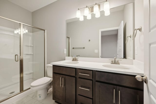 full bathroom featuring a sink, a shower stall, toilet, and double vanity