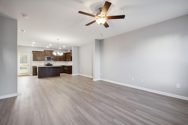 unfurnished living room with visible vents, baseboards, ceiling fan, wood finished floors, and recessed lighting