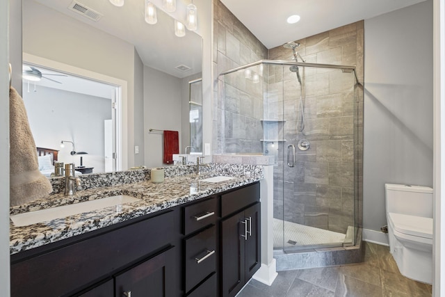 full bathroom with toilet, double vanity, visible vents, and a sink