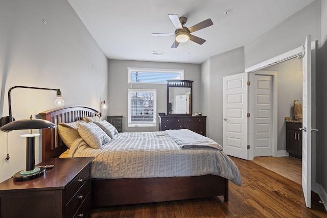 bedroom with ceiling fan, visible vents, and dark wood finished floors