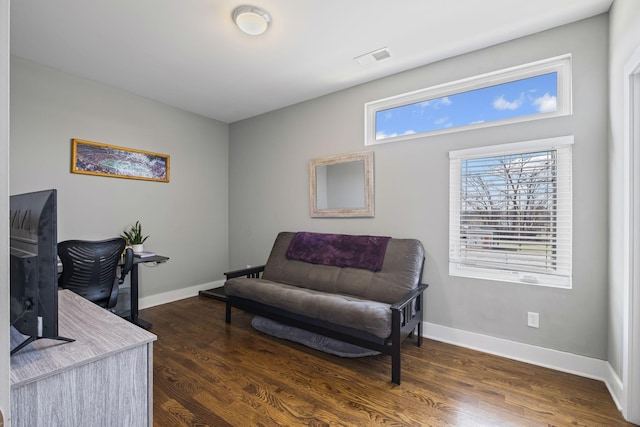 living area featuring visible vents, baseboards, and dark wood-type flooring