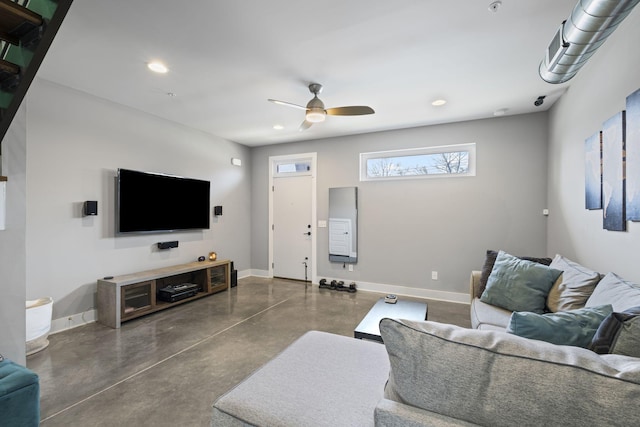 living area featuring finished concrete floors, baseboards, and recessed lighting