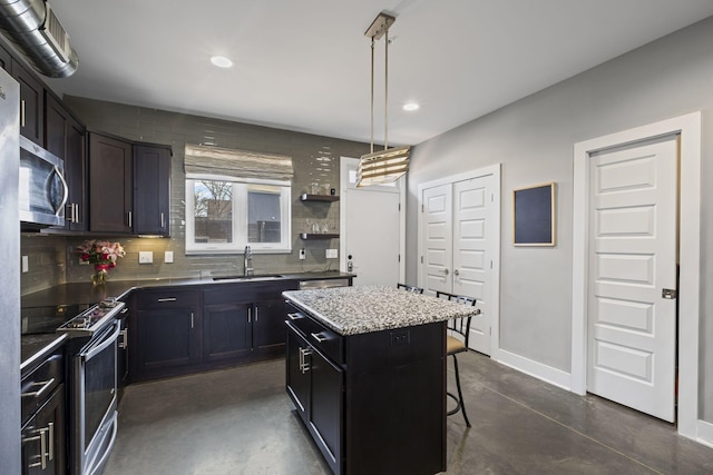 kitchen featuring a kitchen island, pendant lighting, stainless steel appliances, open shelves, and a sink