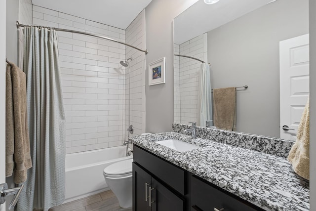 bathroom with shower / bath combination with curtain, vanity, toilet, and wood finished floors