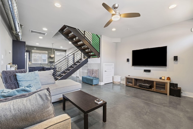 living area featuring recessed lighting, visible vents, stairway, concrete floors, and baseboards