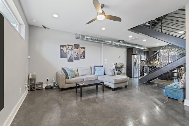 living area featuring recessed lighting, a ceiling fan, baseboards, stairway, and finished concrete floors