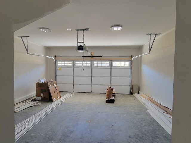 garage with a garage door opener and baseboards