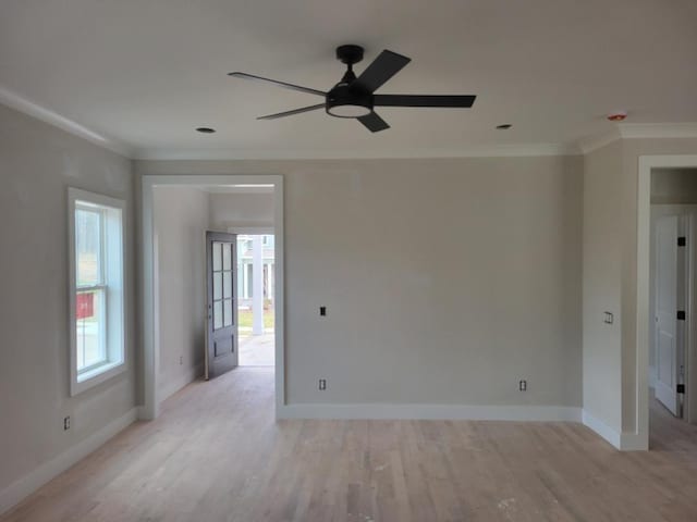 empty room with light wood-type flooring, crown molding, baseboards, and ceiling fan