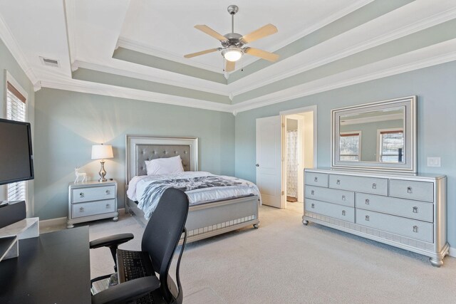 bedroom with a raised ceiling, light carpet, crown molding, and visible vents