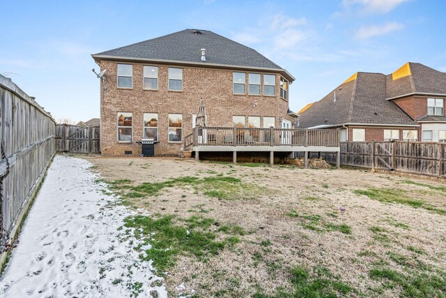 rear view of property featuring a fenced backyard, crawl space, a gate, a deck, and brick siding