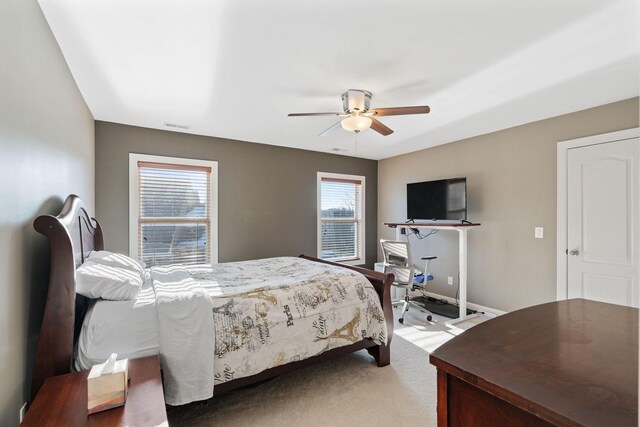 carpeted bedroom with visible vents, ceiling fan, and baseboards