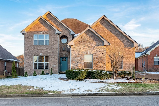 traditional-style home with stone siding and brick siding