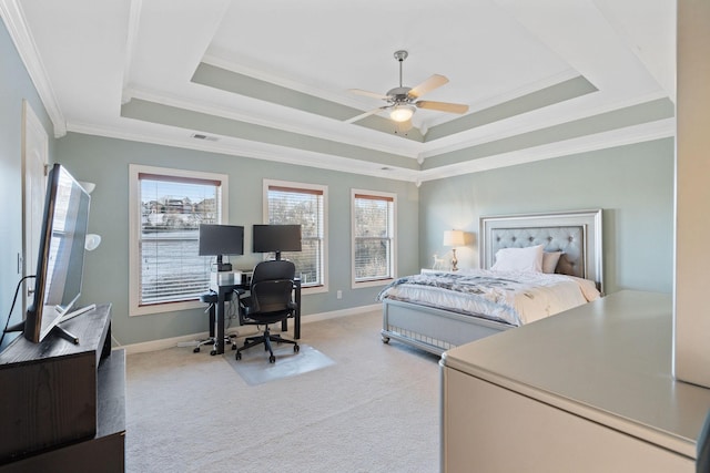 carpeted bedroom with multiple windows, a raised ceiling, and baseboards