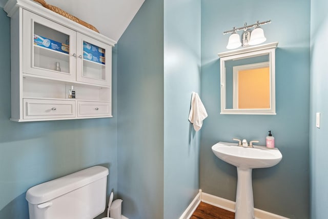 bathroom with toilet and baseboards