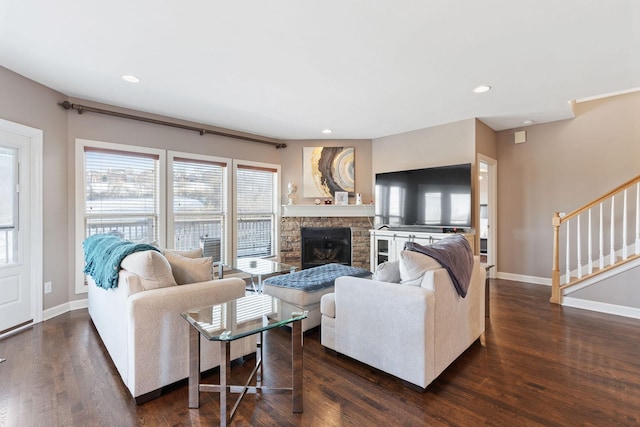 living room with stairs, baseboards, a fireplace, and dark wood-type flooring