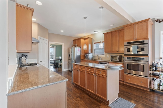 kitchen featuring light stone countertops, pendant lighting, stainless steel appliances, and dark wood-style flooring