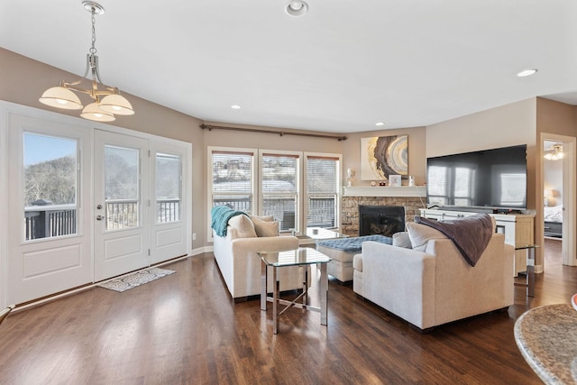 living room with a fireplace, dark wood-type flooring, and recessed lighting