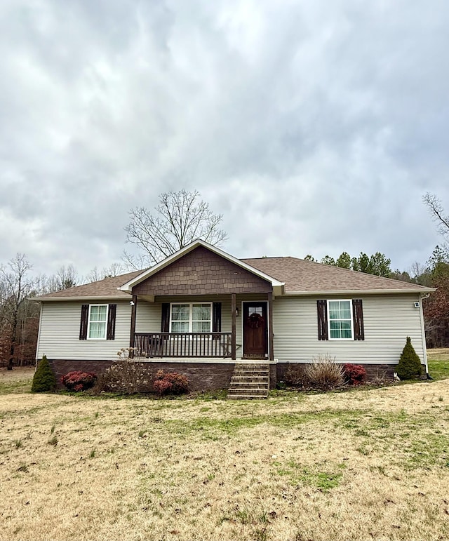 ranch-style house with a porch and a front yard