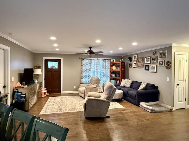 living area with crown molding, wood finished floors, and recessed lighting