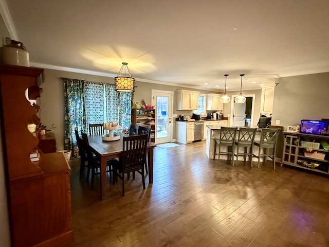 dining space featuring crown molding and wood finished floors