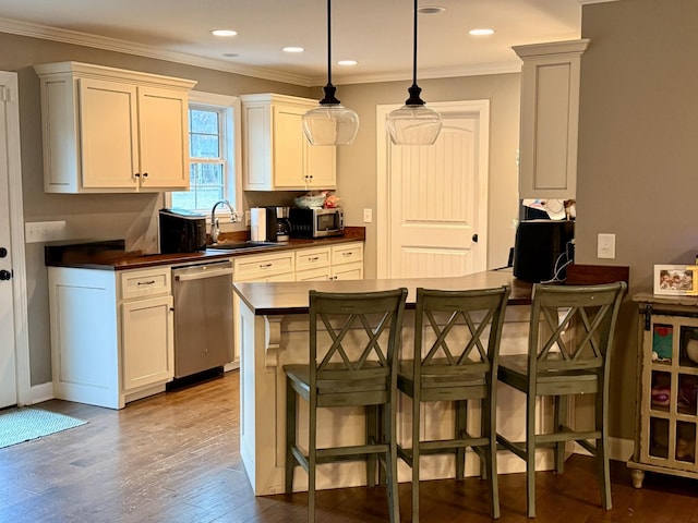 kitchen featuring dark countertops, white cabinetry, appliances with stainless steel finishes, and a sink