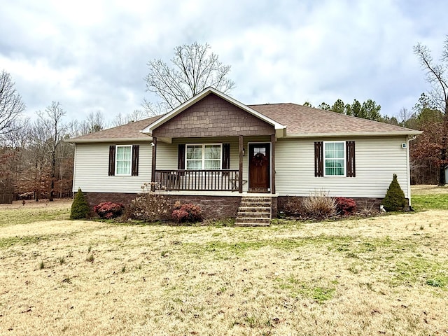 ranch-style home with a porch, a front yard, and a shingled roof