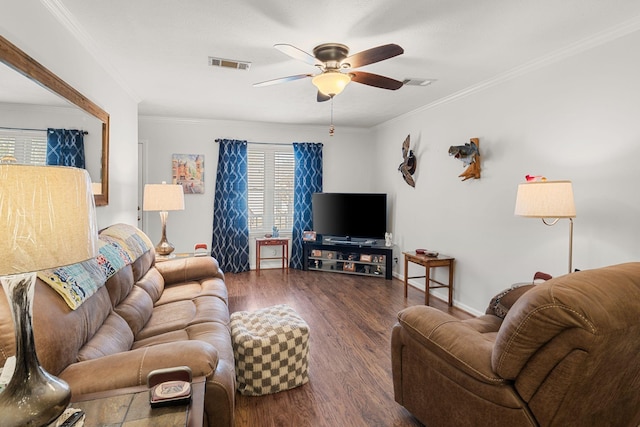 living room featuring ceiling fan, dark wood-style flooring, visible vents, and crown molding