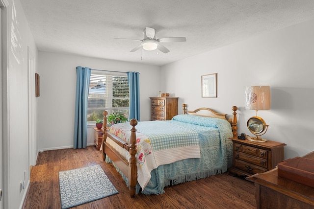 bedroom featuring ceiling fan, a textured ceiling, baseboards, and wood finished floors