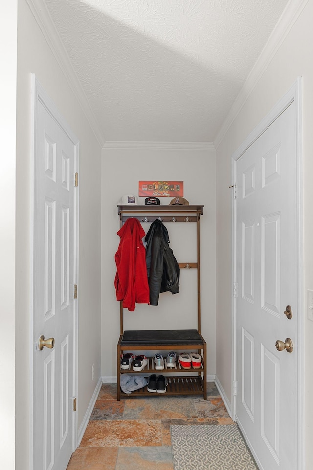 mudroom with stone finish flooring, crown molding, a textured ceiling, and baseboards