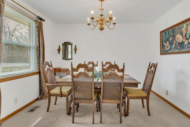 dining space with a chandelier, visible vents, light carpet, and baseboards