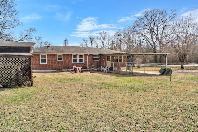 back of property featuring a pergola, fence, a yard, a carport, and brick siding