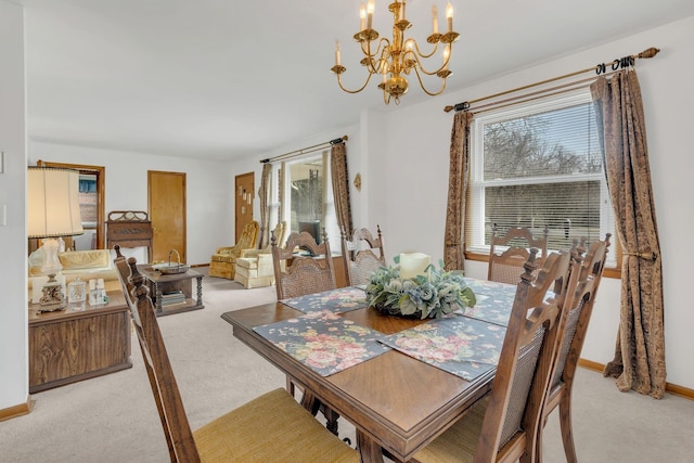 dining room with light carpet, a chandelier, and a healthy amount of sunlight